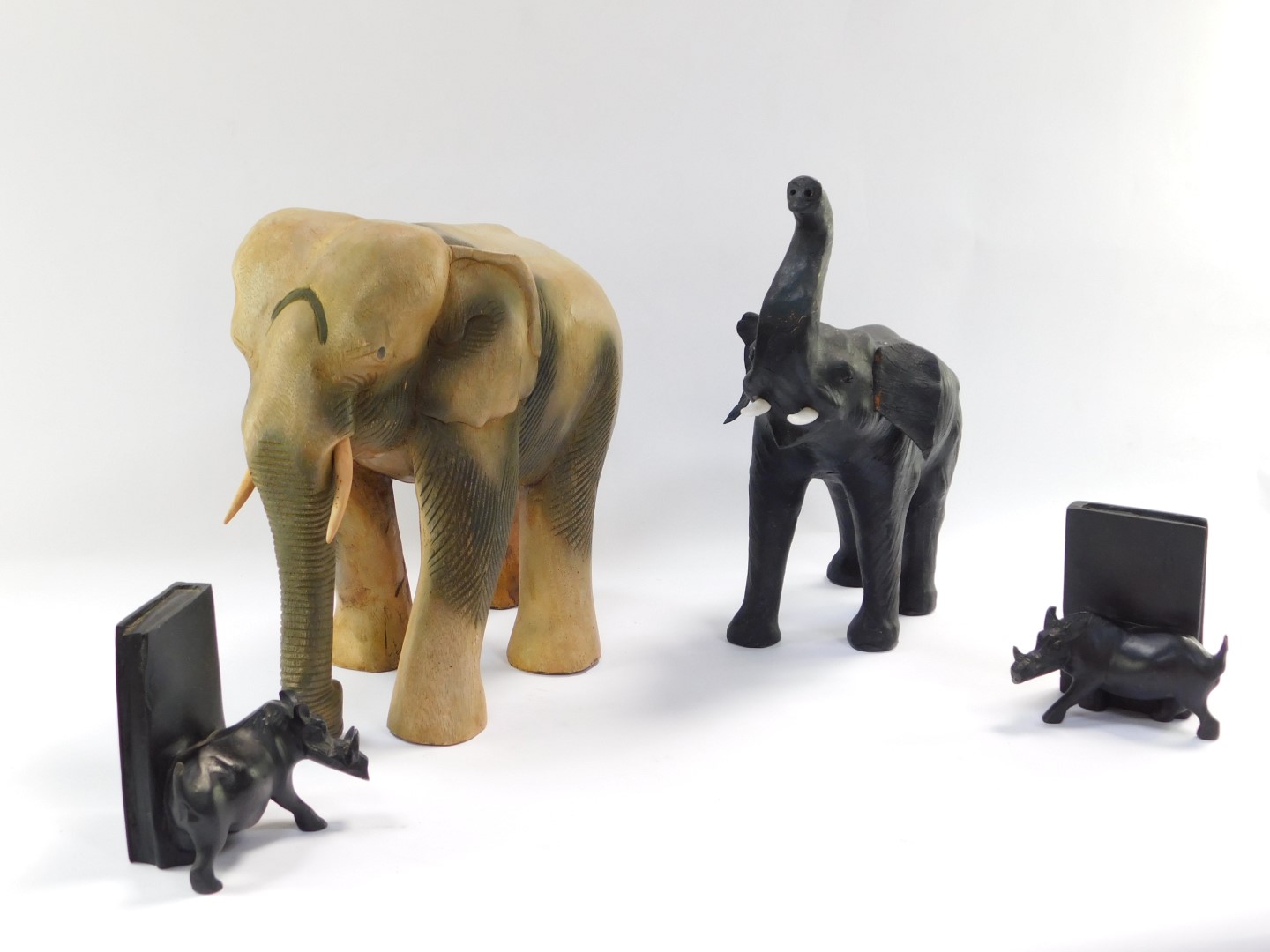A group of carved wooden ornaments, comprising a large elephant 33cm high, a black stained - Image 2 of 4