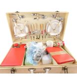 A Brexton picnic hamper, in cream spotted case, with brass buckles and supports, with plastics