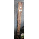 A carved wooden digeridoo.