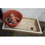 A ceramic sink and a group of terracotta planters. (a quantity)