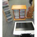 Two wooden cased CD racks, carved religious figure and a computer monitor. (4)