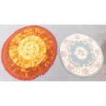 Two round rugs, one having brown and orange design. (2)