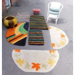 Various rugs, a white Lloyd Loom chair, cushion, turtle footstool and a pink footstool. (a quantity)