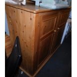 A substantial pine kitchen cupboard, with two doors.