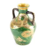 An unusual 19thC pottery two handled vase, hand painted with serpent on green ground, with R diamond