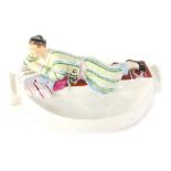 A 20thC Danko Russian porcelain ashtray, with a reclining figure to the back, polychrome decorated i