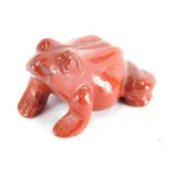 A 20thC polished brown glass figure of a frog, in the manner of Lalique, unsigned, 4cm wide.