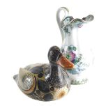 A South American pottery duck, decorated with flowers on a fawn ground marked beneath, 18cm high, an