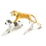 A USSR pottery recumbent dog, 27cm long, another and a tiger marked USSR. (3)