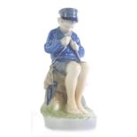 A Royal Copenhagen figure of a seated child, number 905, marked beneath, 19cm high.
