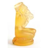 A 20thC Lalique amber coloured glass figure of a mermaid, kneeling, script mark, 9cm high.