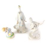 Three various 20thC Russian or Ukrainian porcelain figures, to include girl holding bird, 13cm high,