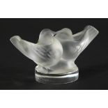 A 20thC Lalique frosted and clear glass figure group of two birds, signed, 5cm high.