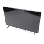 A Samsung 32 inch colour television, in silvered trim with remote control and wire.
