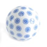 A 20thC blue and white pottery carpet bowl, decorated with flower head, 8cm diameter.