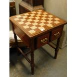 A mahogany games table, with two drawers on turned supports.