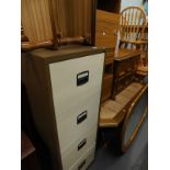 A four drawer filing cabinet, two tier coffee table, various other furnishings, tile top coffee