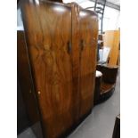 An unusual 1950's/1960's walnut dressing table with two circular cupboards and a matching wardrobe.