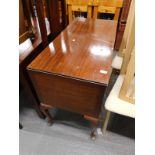 A mahogany dressing table with three drawers, on cabriole legs.