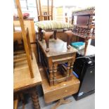 A mahogany drop leaf coffee table, nest of three oak tables, and a stool. The upholstery in this lot