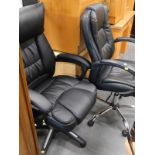 A modern black leather upholstered office chair, and another similar.