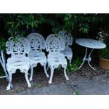 A cast patio table and chair set. (5)