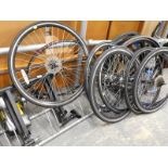 A quantity of bicycle parts, to include wheels, tyres, a stand, etc.