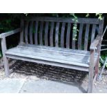 A hardwood slatted bench and 2 mobility aids.