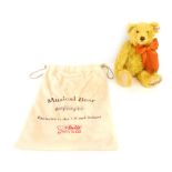 A Steiff musical bear, Exclusive to the UK and Ireland 26cm high, in cloth bag.