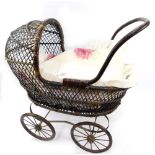 A steel framed wicker dolls pram, with fitted interior.