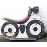 A fairground ride wooden motorcycle, painted in white and black, on metal framed base with metal han