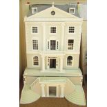 A substantial Georgian style doll's house, with white and grey painted brick finish, with swing step