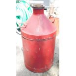 A metal oil drum, painted in red, 60cm high.