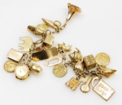 An oval link identity charm bracelet, yellow metal with twenty four charms as fitted, on a bolt ring