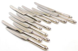 A set of six Elizabeth II silver handled dessert knives and dinner knives, each handle of plain form