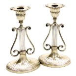 A pair of Victorian silver Neo-Classical candlesticks, of lyre form raised on an oval fluted base, 2