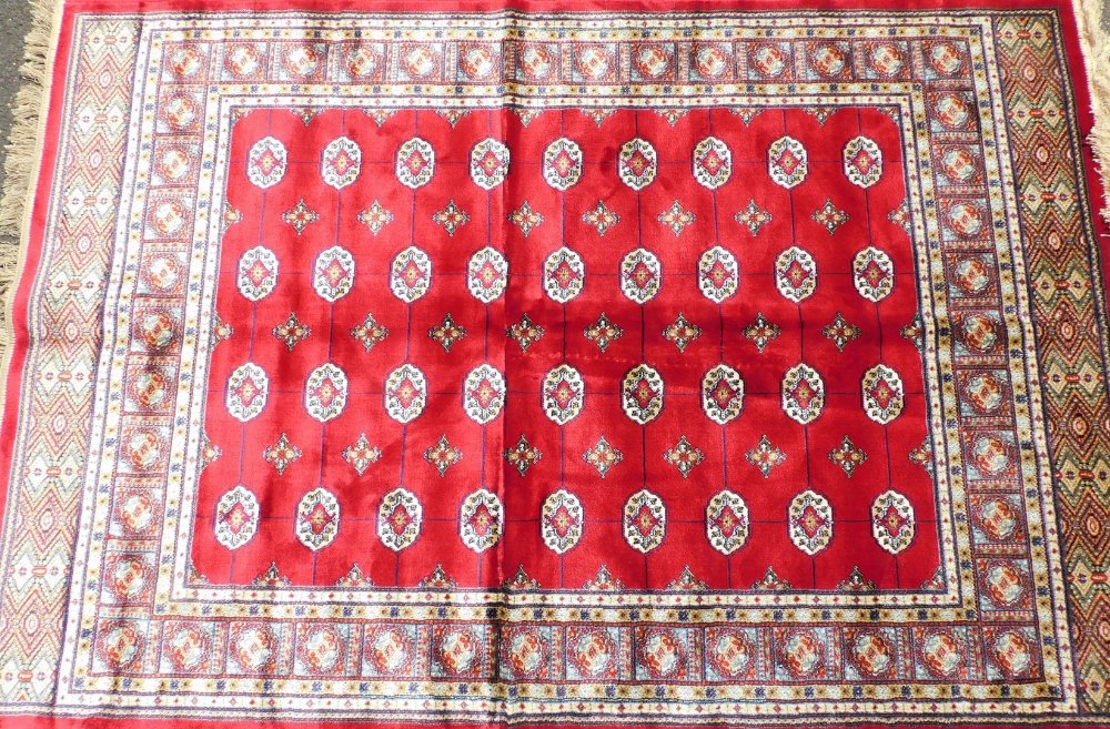 A Bokara Cashmere rug, on red ground with all over design, 170cm x 120cm.