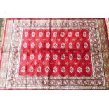 A Bokara Cashmere rug, on red ground with all over design, 170cm x 120cm.