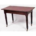 A Victorian style mahogany library table, with a gilt and red leather inset top, raised on turned an
