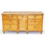 A Victorian pine and mahogany dresser base, with a central drawer over a cupboard door flanked to ea