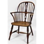 A 19thC yew and elm Windsor chair, by Amos, Grantham, with a pierced vase shaped splat, solid saddle