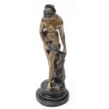 A bronzed metal figure of Venus, modelled standing, shell at her feet, raised on a socle base, 37cm