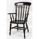 A Victorian stained ash and elm kitchen chair, with solid saddle seat, raised on turned legs united