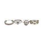 Four silver dress rings, each marked TGGC, each of stone set design comprising an eternity ring, hal