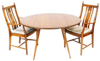 An Ercol dark elm drop leaf dining table, raised on square splayed legs, circa 1970, model number 38