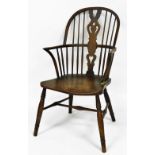 A Victorian beech and elm Windsor chair, with a shield shaped splat, solid saddle seat, raised on tu