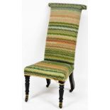 A Victorian mahogany prie dieu chair, upholstered in multi coloured wool work zigzag fabric, raised