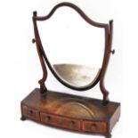 A George III style mahogany and satinwood cross banded swing frame toilet mirror, with a shield shap