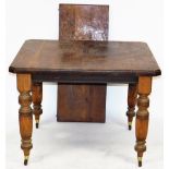 A Victorian walnut wind out dining table, with one additional leaf, raised on turned and fluted legs