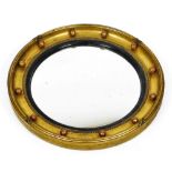 An early 20thC porthole mirror, of circular form, with a bead outline and moulded frame, 40cm diamet